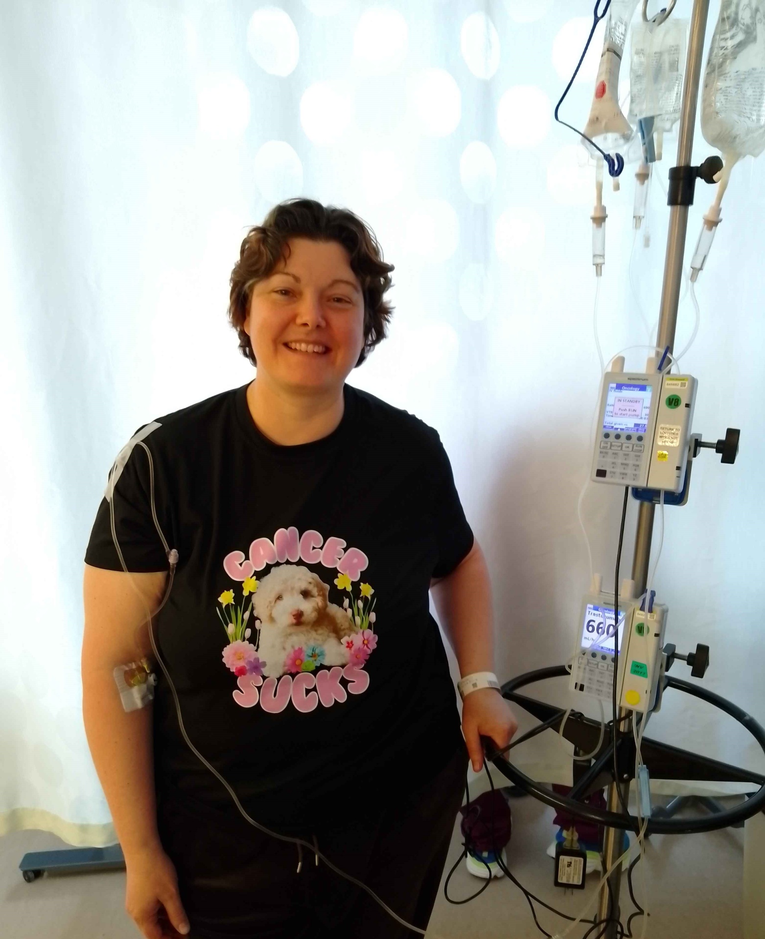 Christina Wilson, Founder and CEO of Tenir Health, smiling during chemotherapy treatment